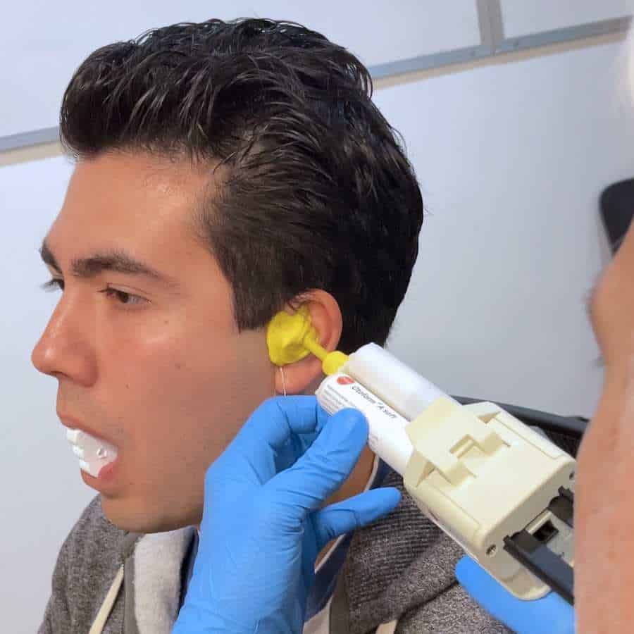 Jamie Larsen taking a custom ear impression