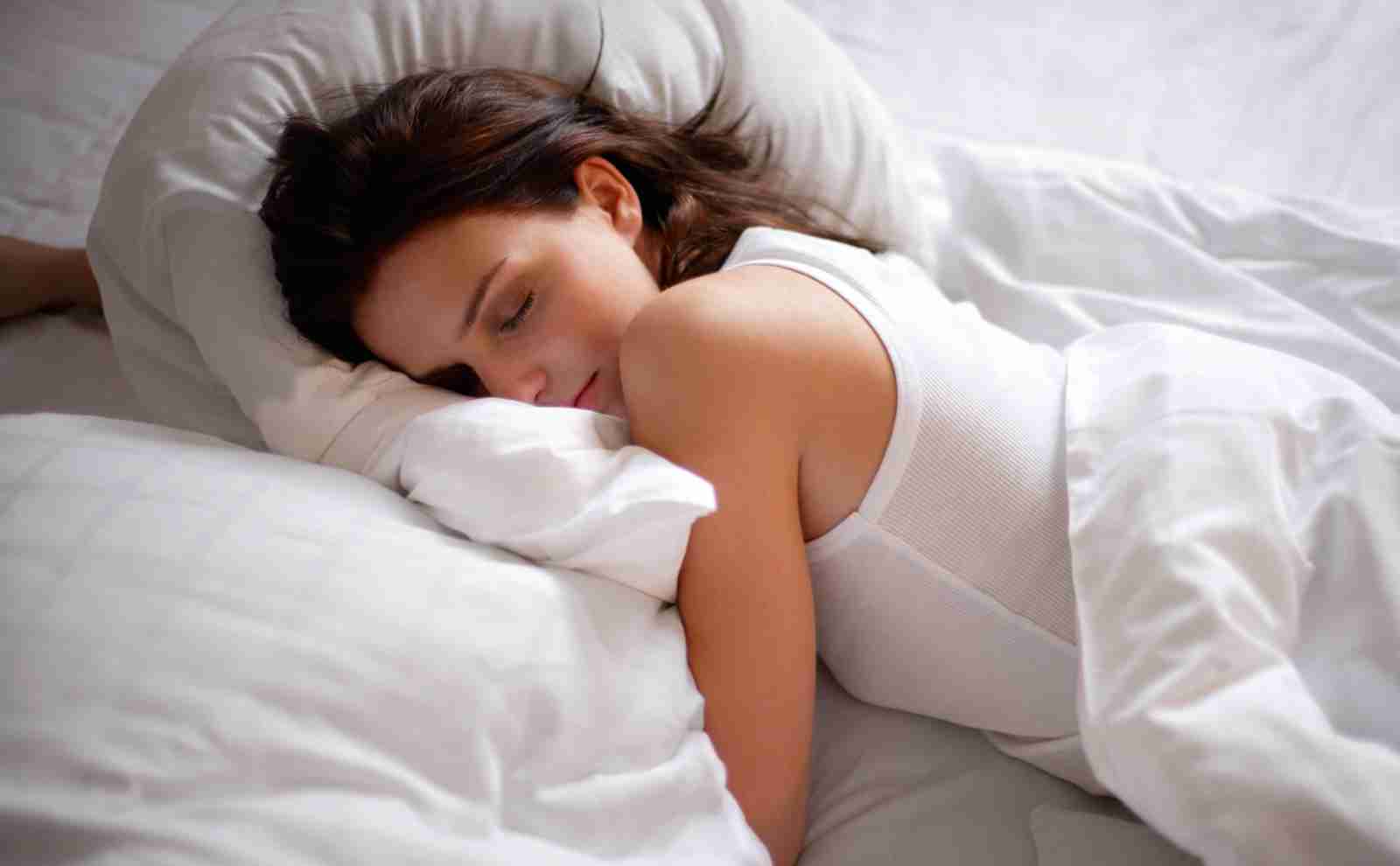 a woman sleeping in a bed