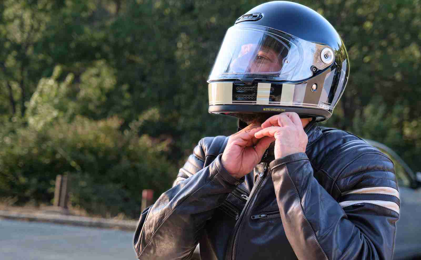a man putting on a motorcycle helmet