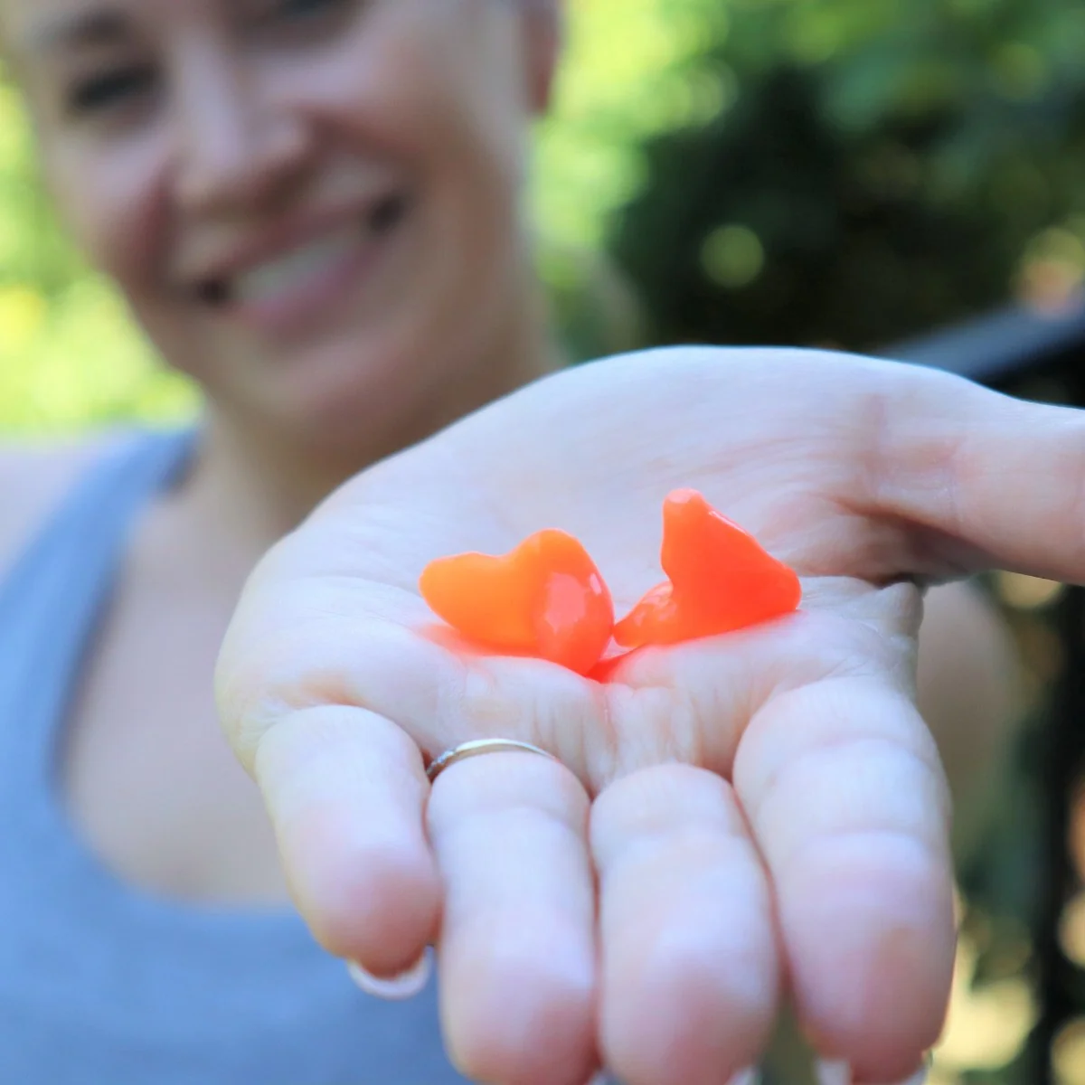 Erin holding custom earplugs in hand